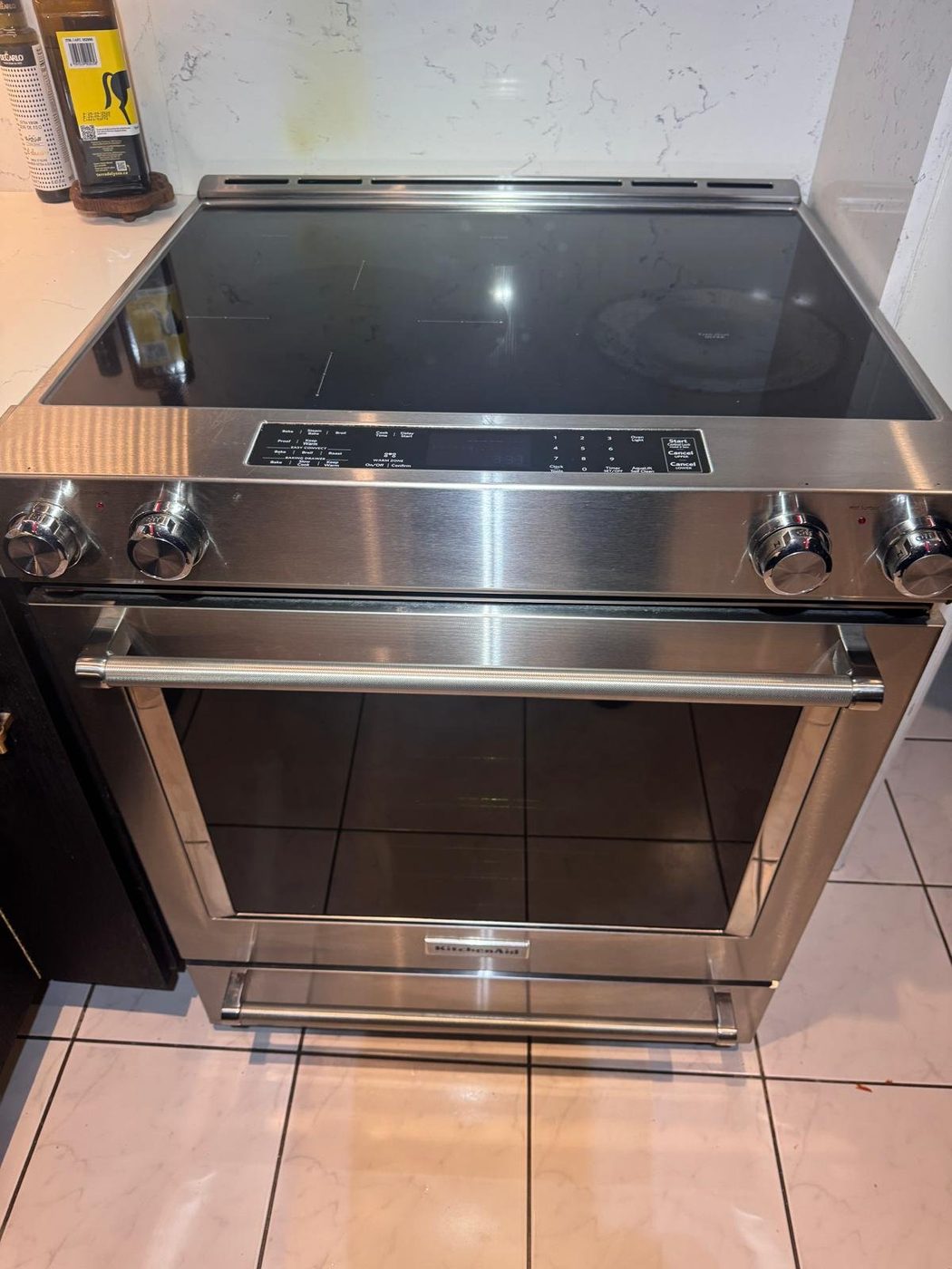 KitchenAid slide-in electric range with smooth glass-ceramic cooktop after repair in a Hamilton, Ontario kitchen by Caspian Appliance Repair