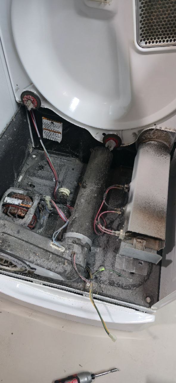 LG dryer interior with drive motor, drum belt, and idler pulley exposed for drum rotation repair by Caspian Appliance Repair in Hamilton, Ontario