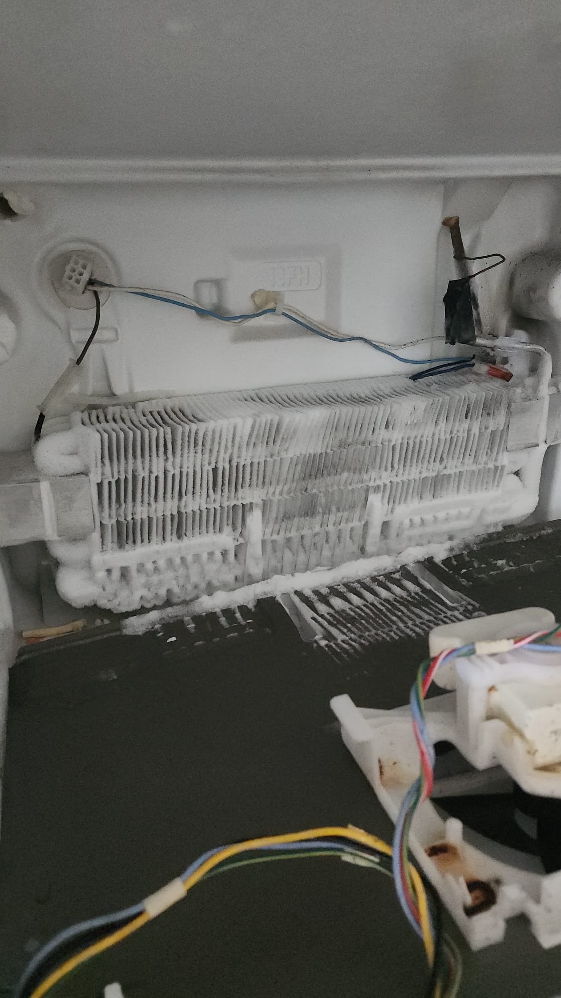 Heavy frost on freezer evaporator coil due to faulty defrost thermostat, repaired by Caspian Appliance Repair Hamilton