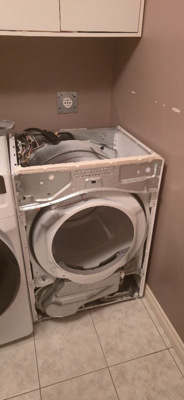 Samsung electric dryer with rear access panel removed during professional repair service in a Hamilton, Ontario laundry room by Caspian Appliance Repair