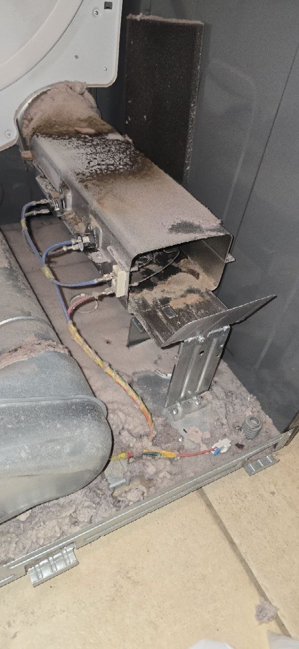 Whirlpool dryer heating element assembly removed for inspection during a no-heat repair by Caspian Appliance Repair technician in Hamilton, Ontario